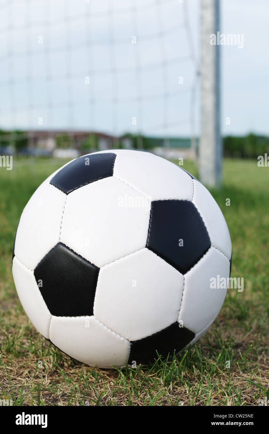 Football on the pitch field with goal in background Stock Photo
