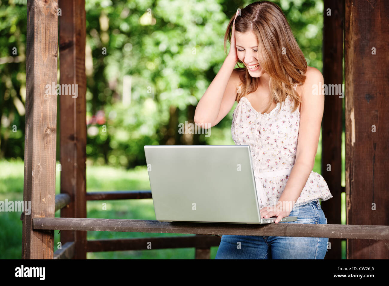 Pretty woman with laptop on summer day outdoor Stock Photo