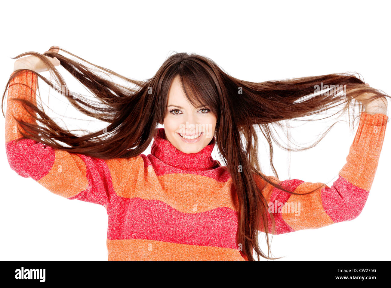 Pretty brunette woman holding her long hair, isolated on white ...
