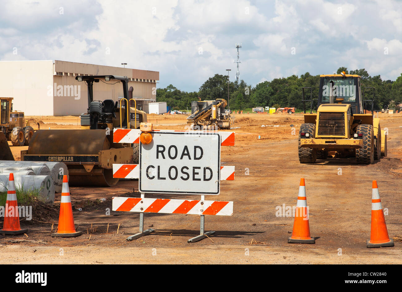 Road closed due to road construction, various road work industrial machinery Stock Photo