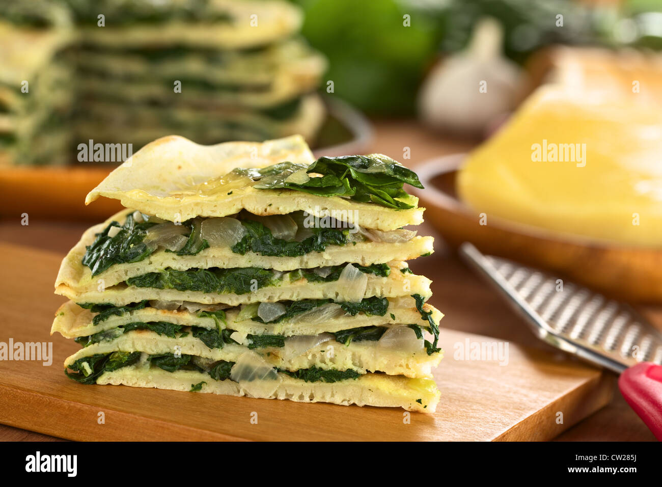 A piece of fresh homemade savory crepes layered with chard (mangold