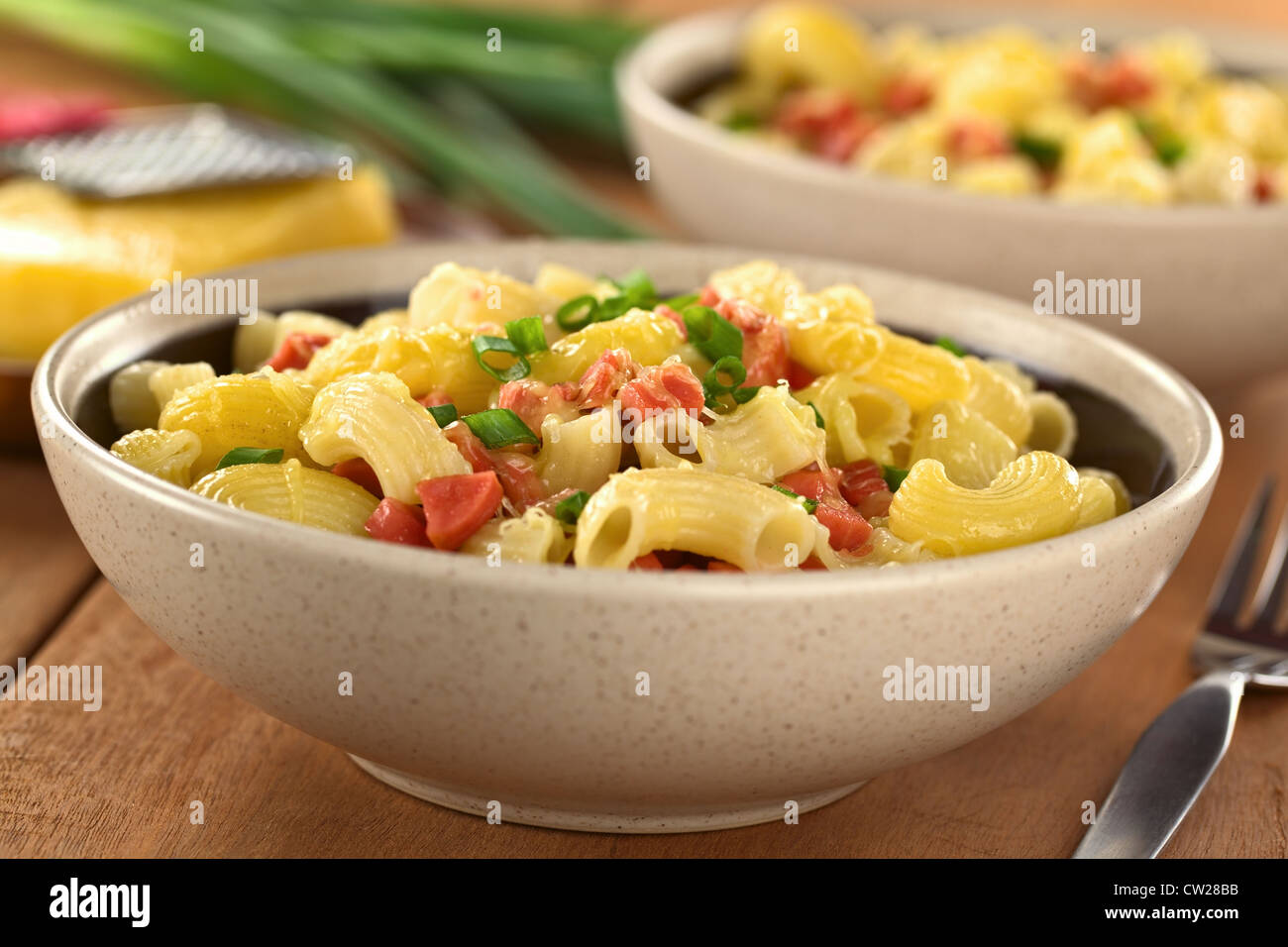 Two bowls full of fresh homemade elbow macaroni pasta with sausage