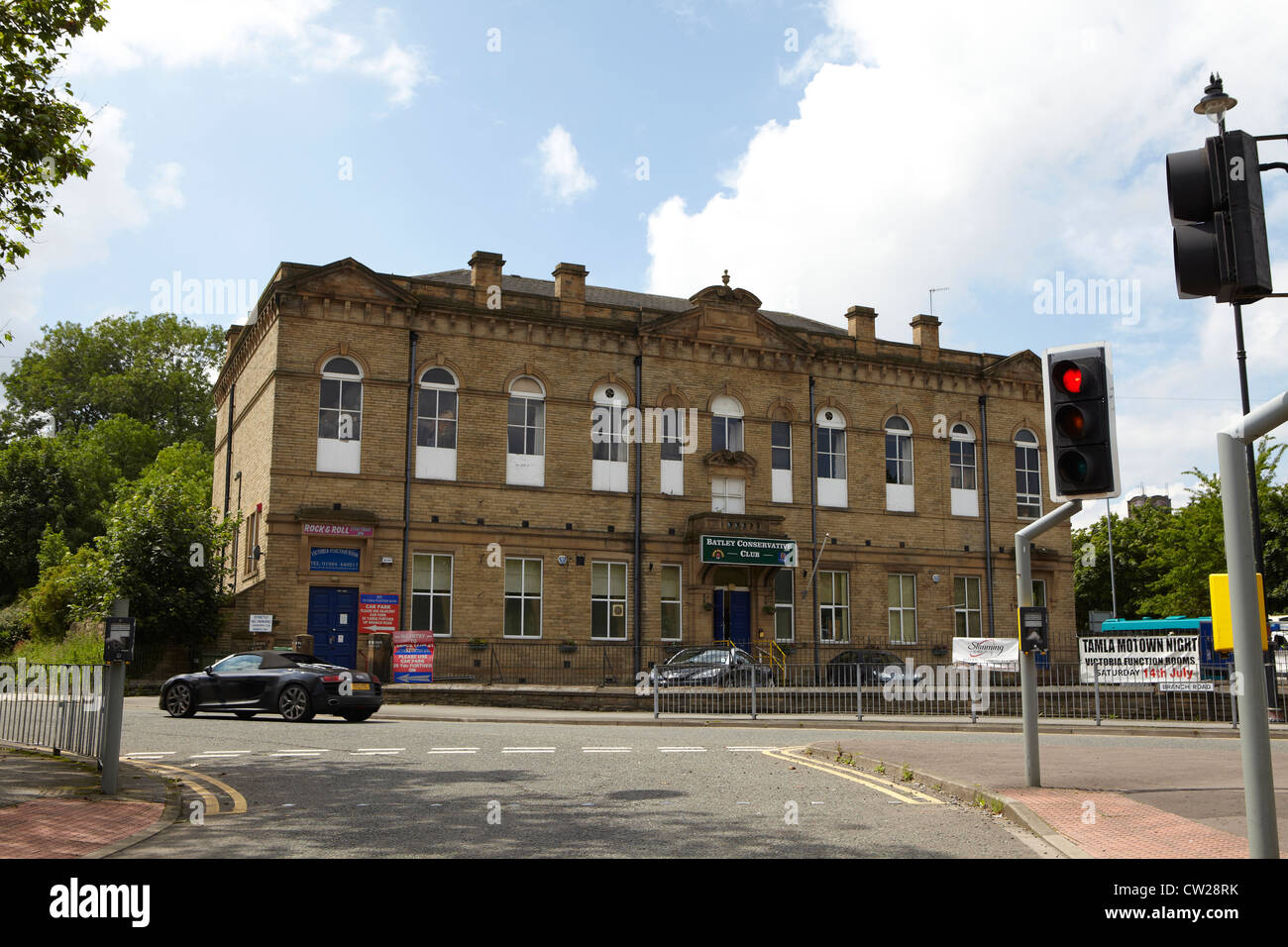 Batley Conservative Club in batley, west yorkshire with a fancy Audi A8 driving by. Stock Photo