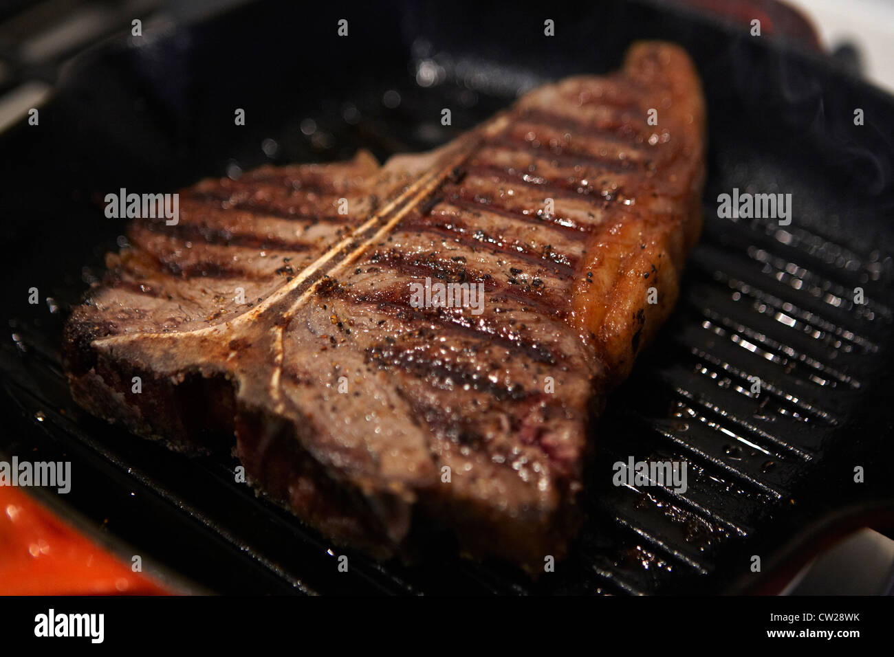 T-bone steak in frying pan getting cooked Stock Photo - Alamy
