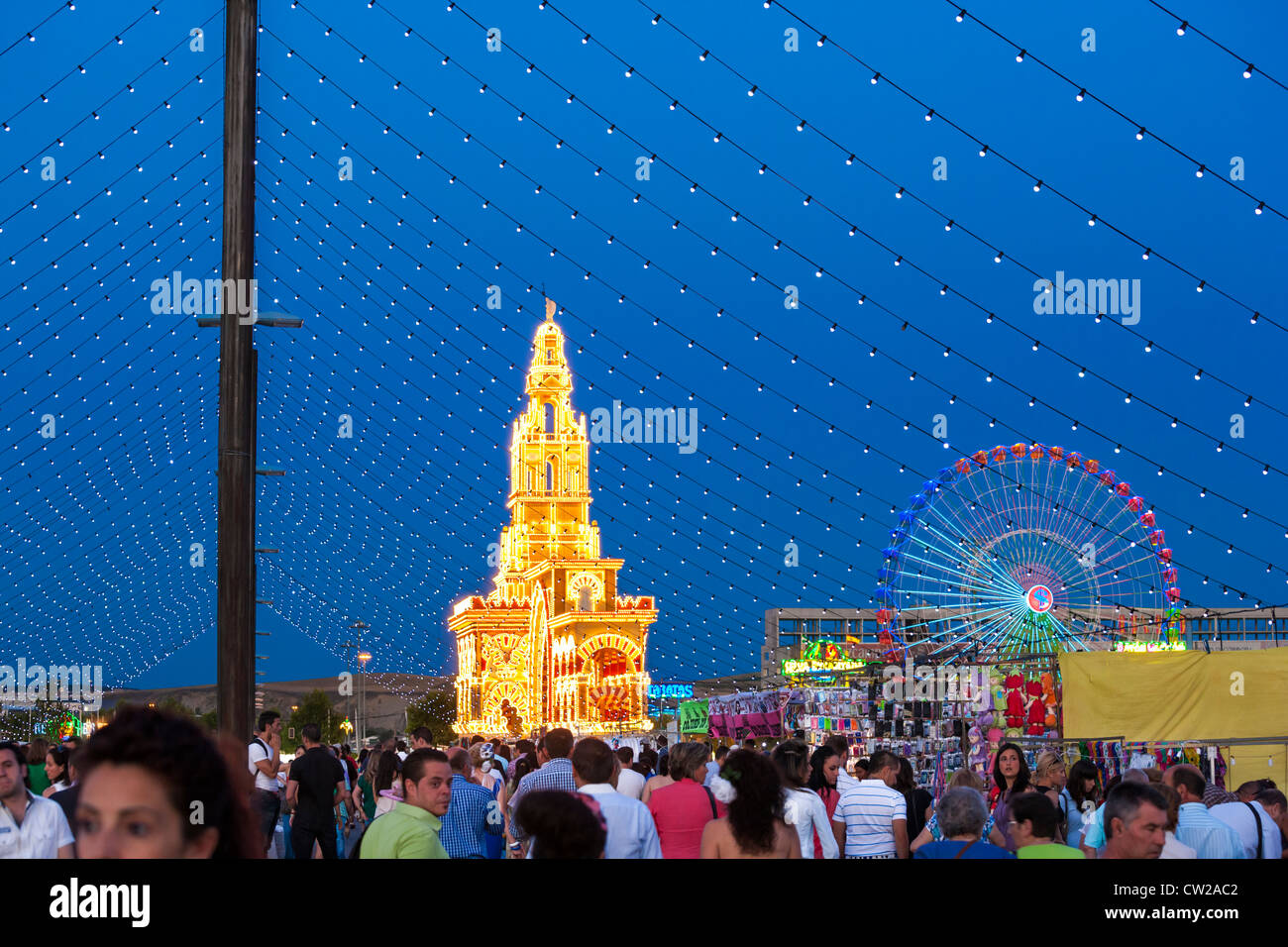 Cordoba, Andalusia, Andalucia, Spain, Crowds coming and going on the way to the fairground for the annual Feria festival in May. Stock Photo