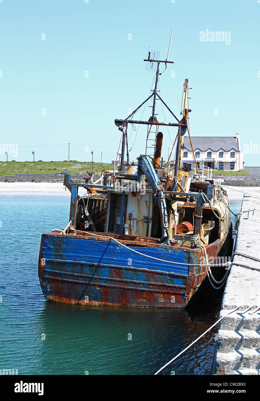 Old fishing boat anchored in the harbor Stock Photo