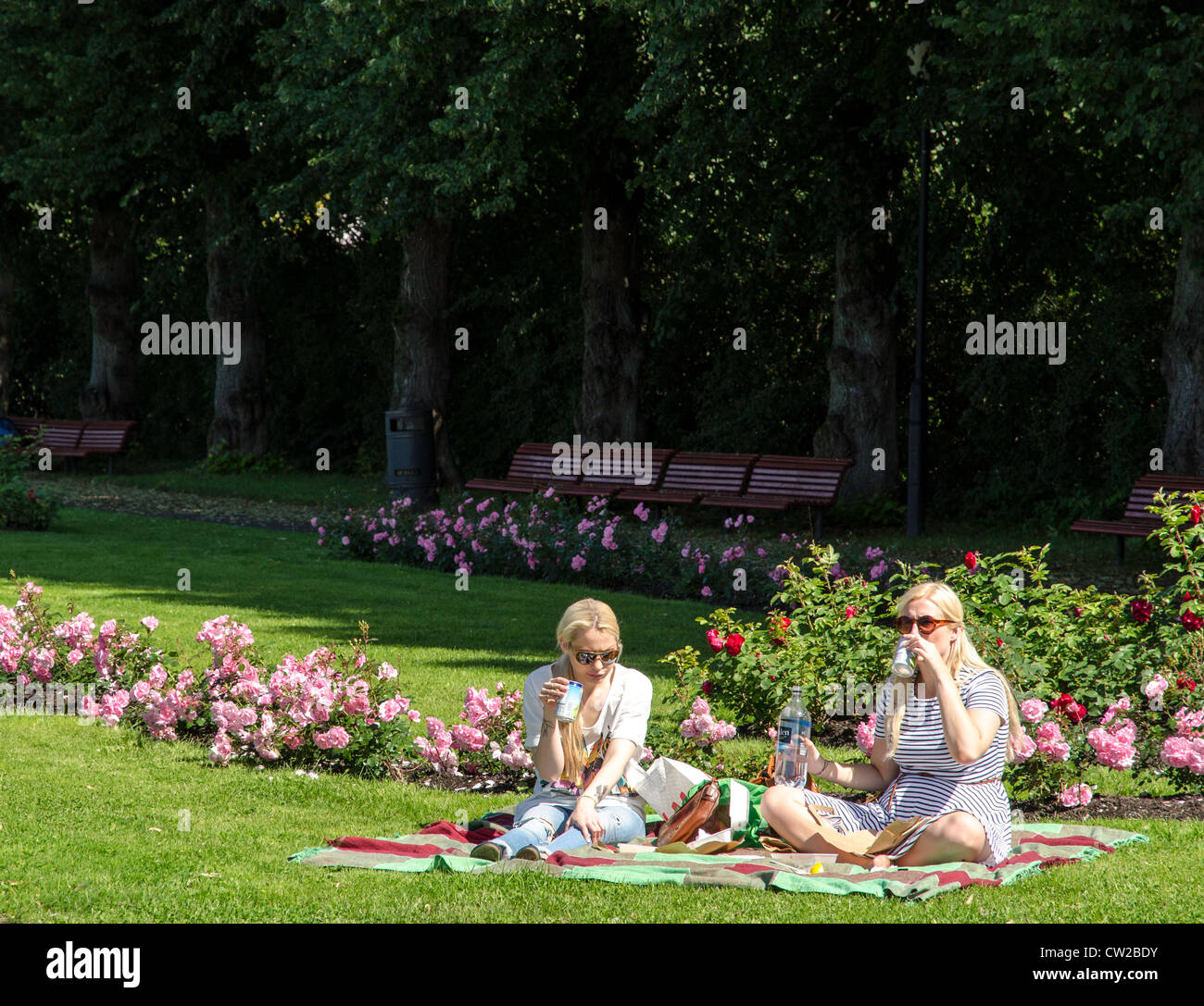 Young Norwegian blond girls having a picnic at Frogner Park Oslo Norway Scandinavia Stock Photo