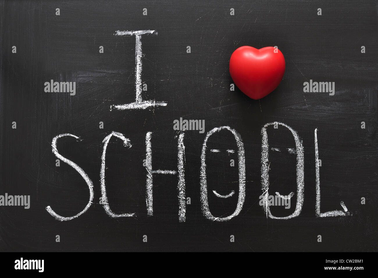 handwritten I love school phrase on the black chalkboard with red heart