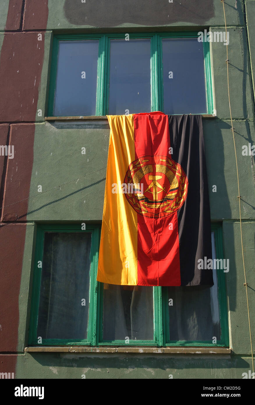 A GDR flag hangs from a window Stock Photo