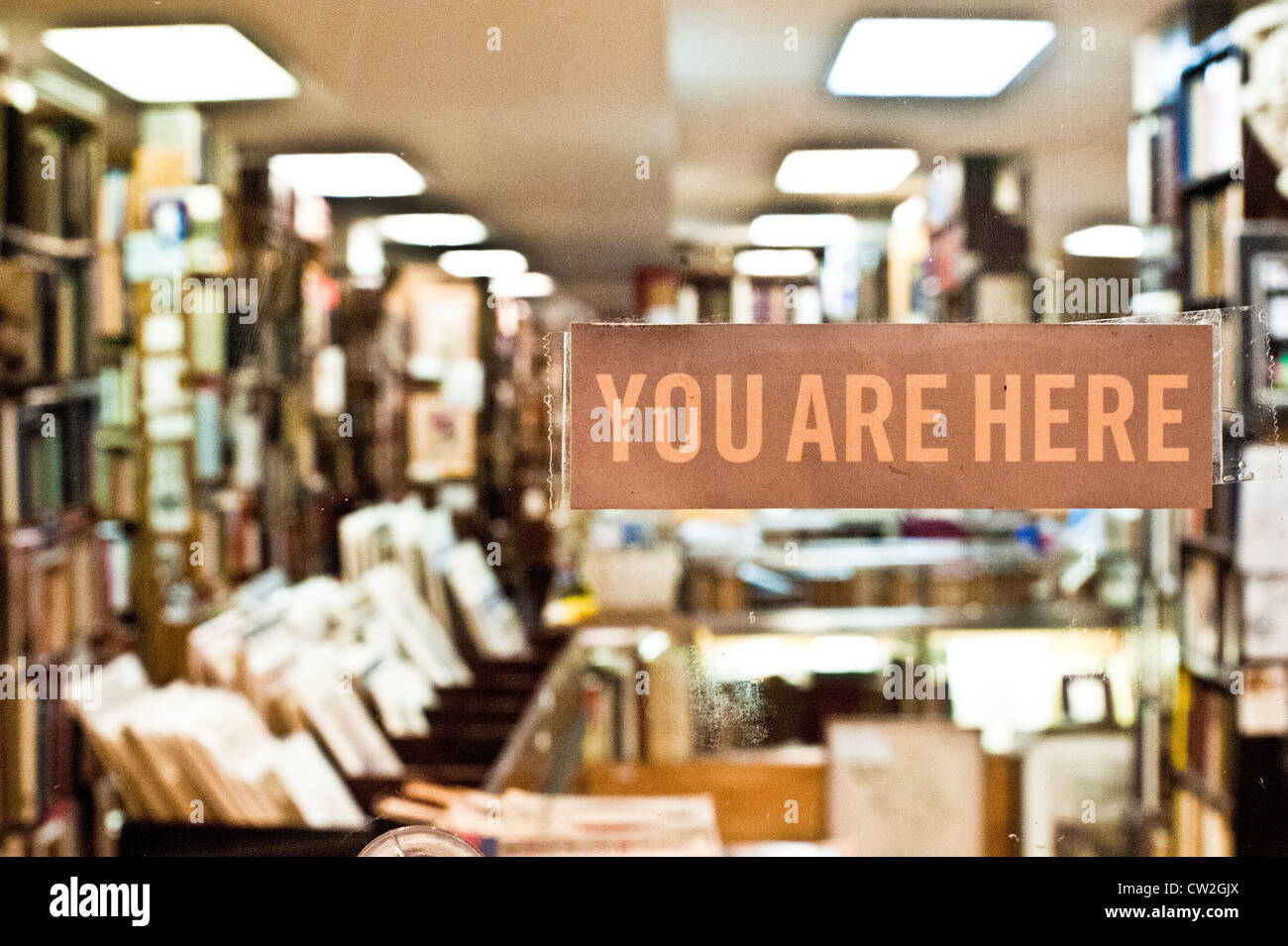 "You are here" sign on window Stock Photo