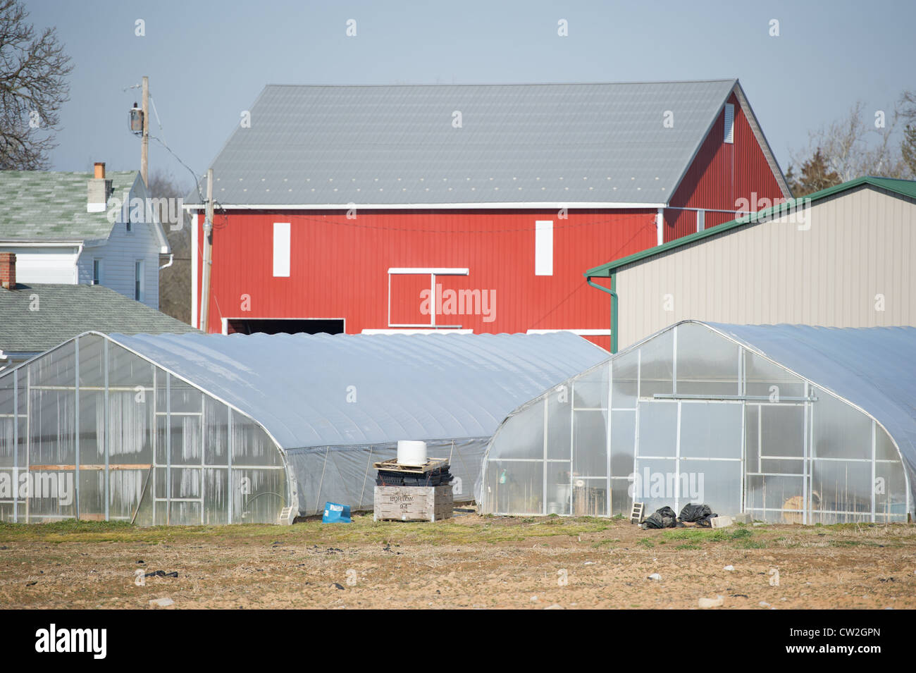 Greenhouses and red barn on a farm Stock Photo