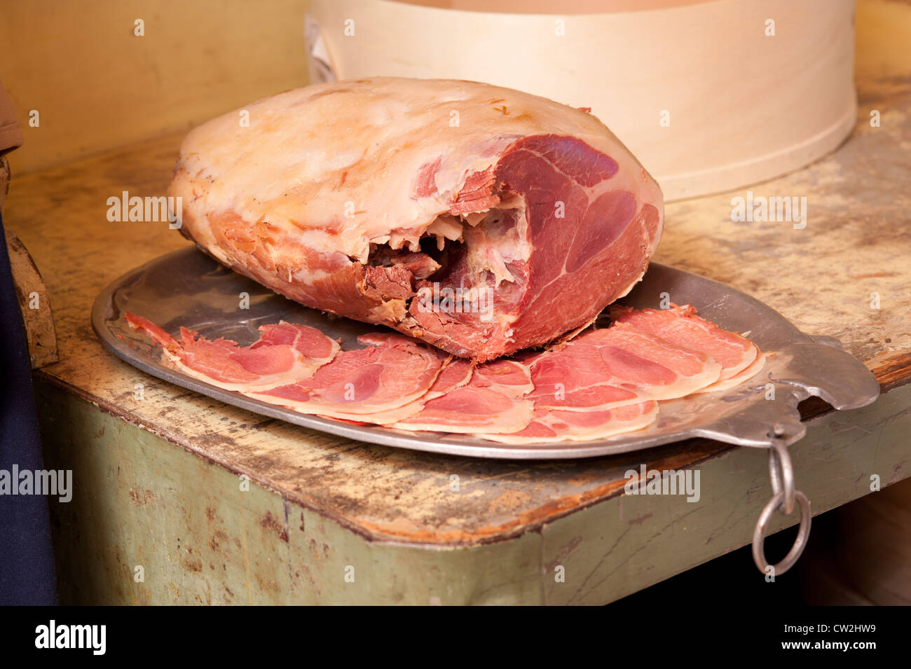 Salt cured ham and slices on tray  Stock Photo