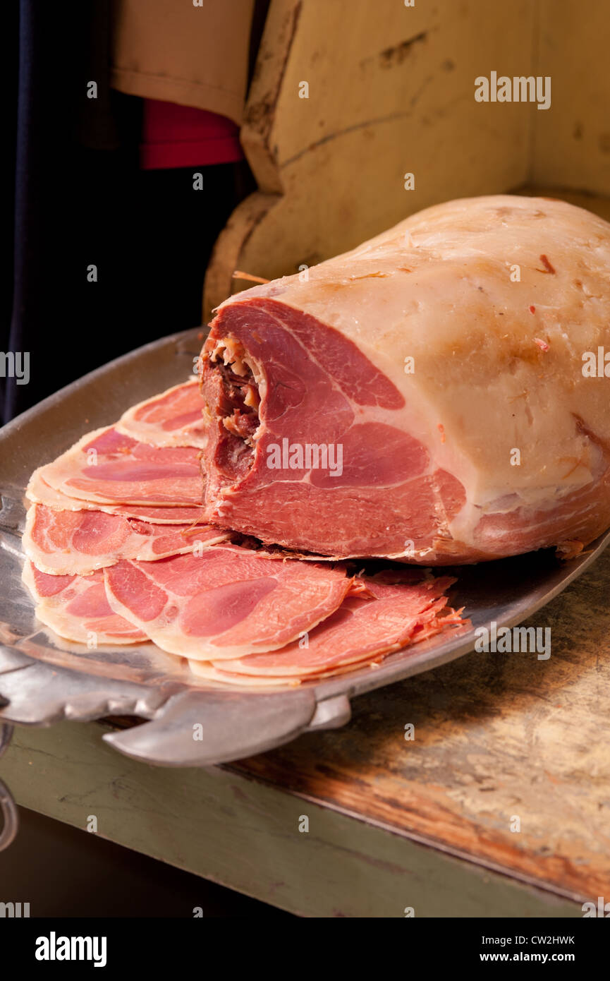 Salt cured ham and slices on tray Stock Photo