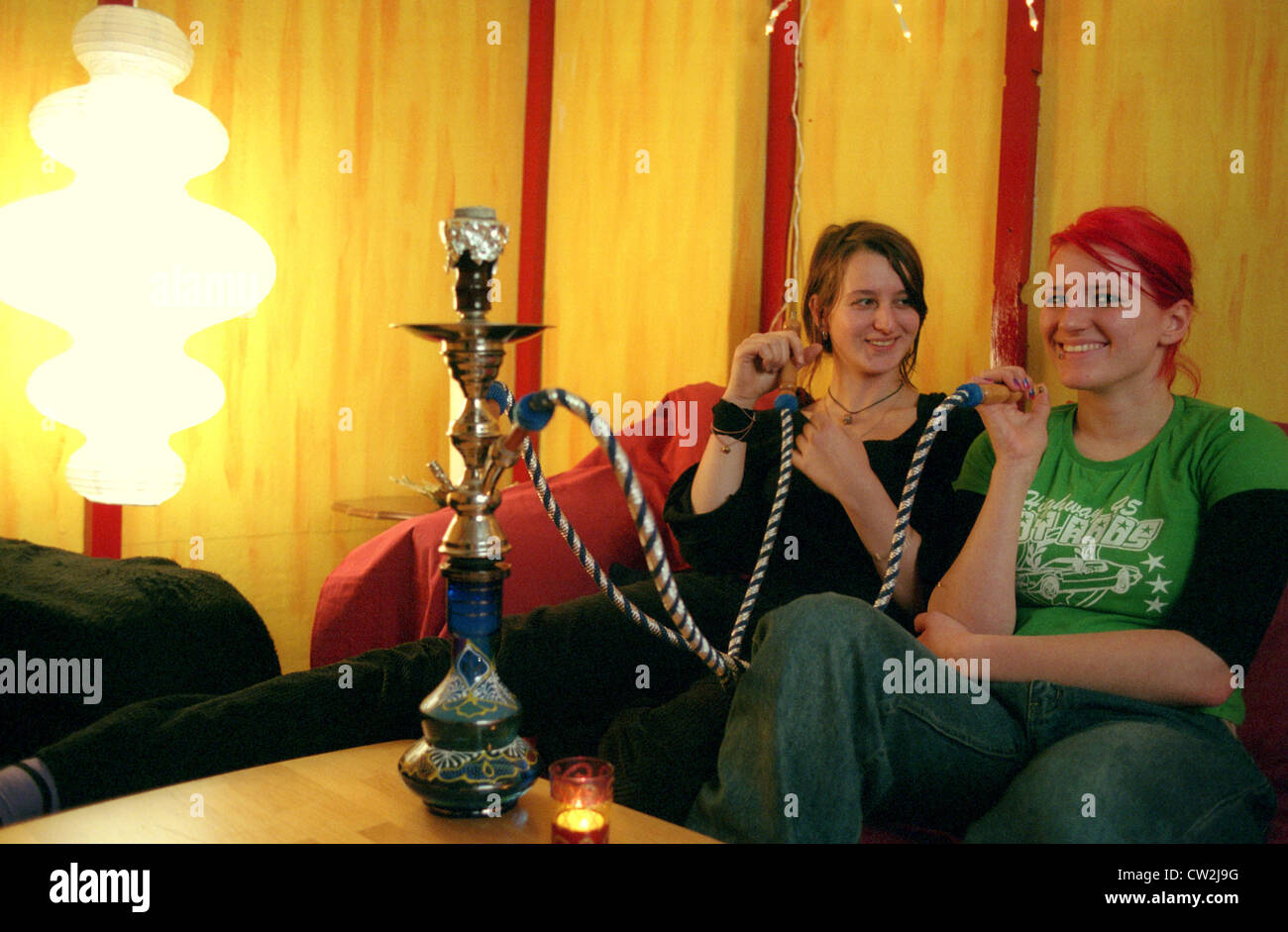 Berlin, two young women smoking hookah Stock Photo Alamy