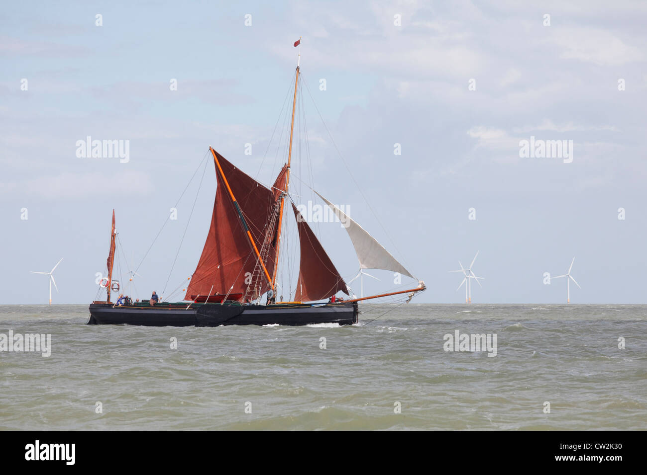 Thames sailing barge in front of a wind farm off the north Kent shore