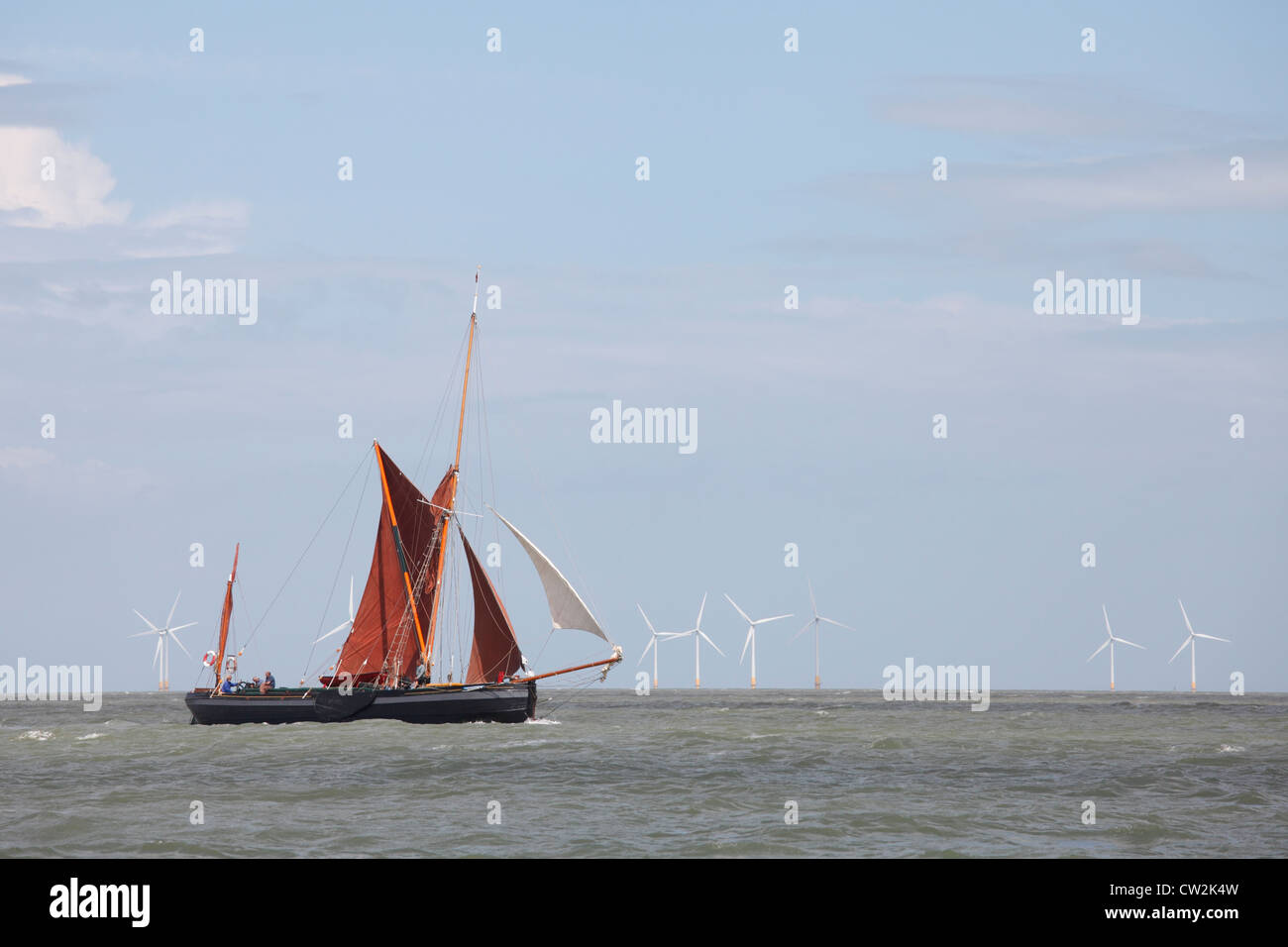 Thames sailing barge in front of a wind farm off the north Kent shore