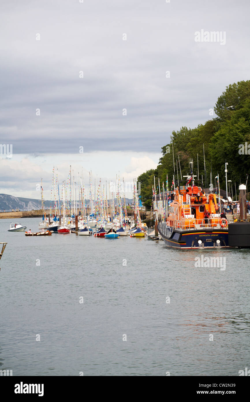 Weymouth lifeboat and yachts decorated with bunting at Weymouth harbour