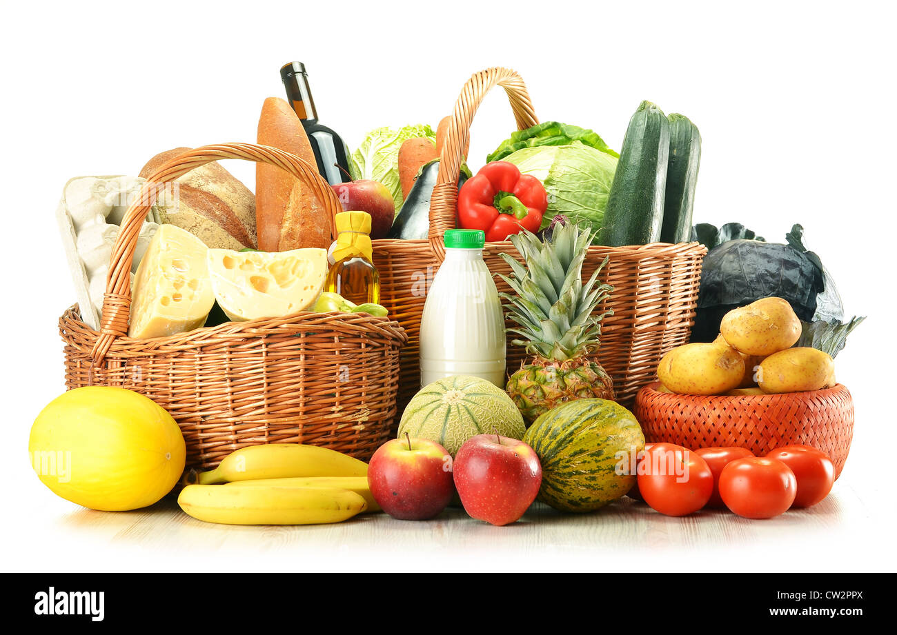 Groceries in wicker basket isolated on white Stock Photo Alamy