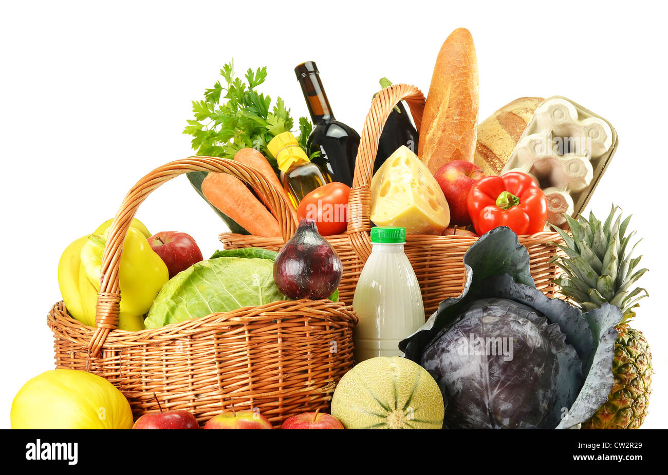 Groceries in wicker basket isolated on white Stock Photo Alamy