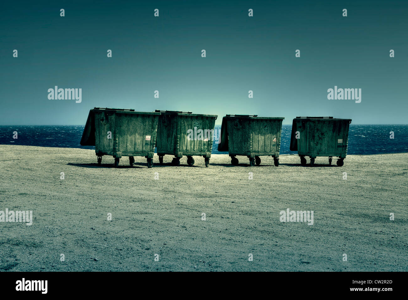 four dumpsters on the shores of the Sea Stock Photo
