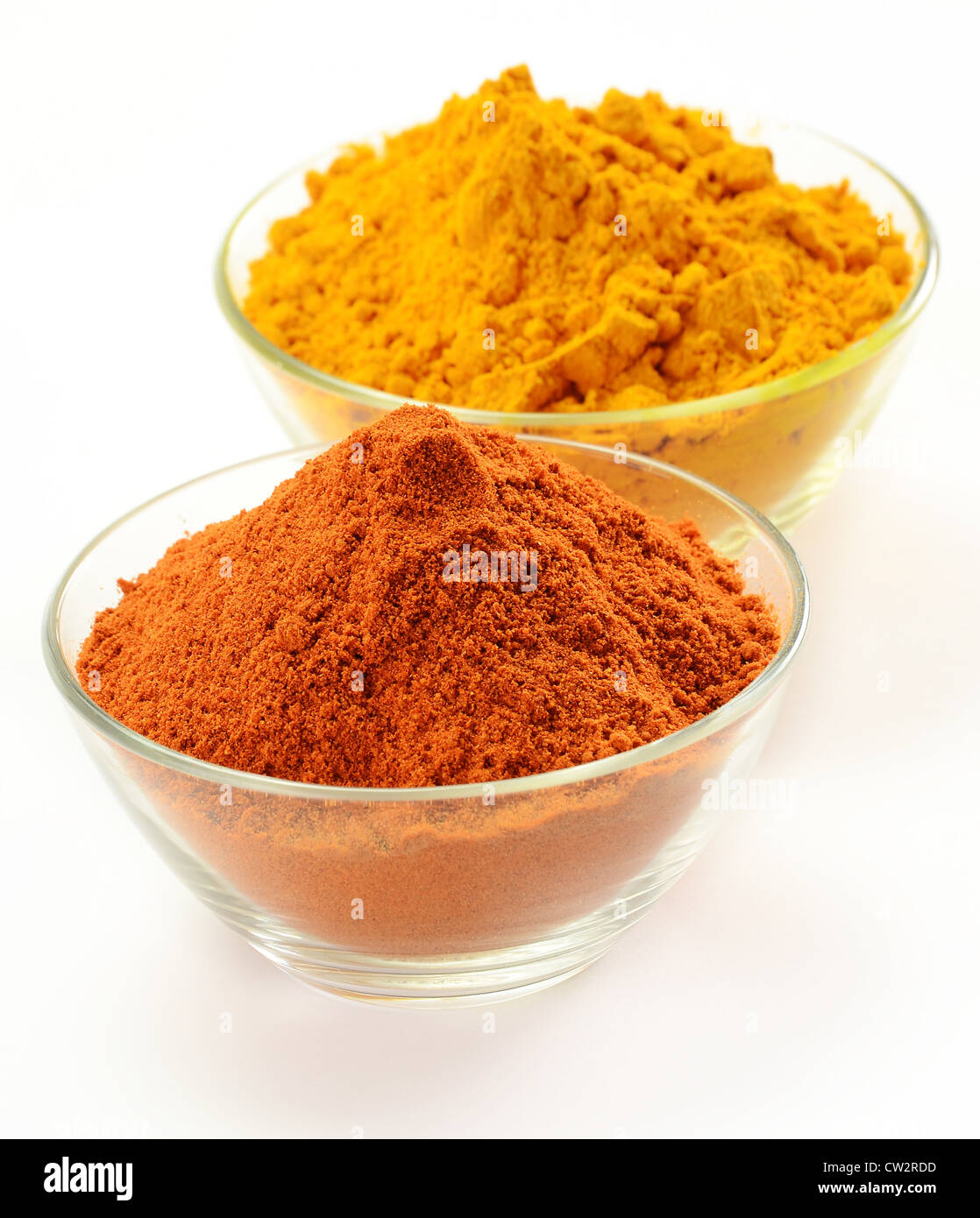 Small dishes with cayenne pepper and turmeric isolated on white Stock Photo