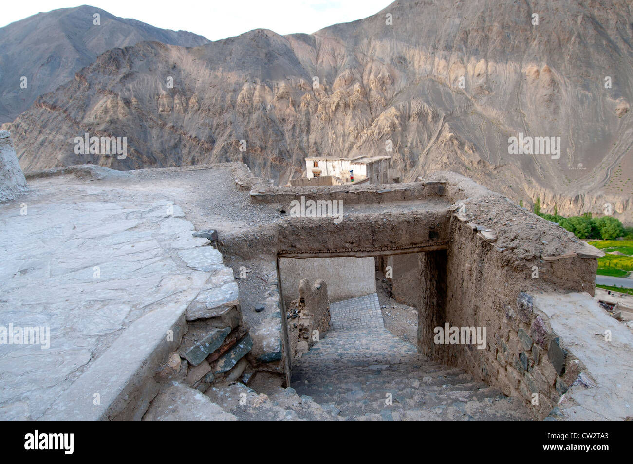 A concrete covered cobblestone walkway between buildings at Lamayuru Monastery in Ladakh, India Stock Photo