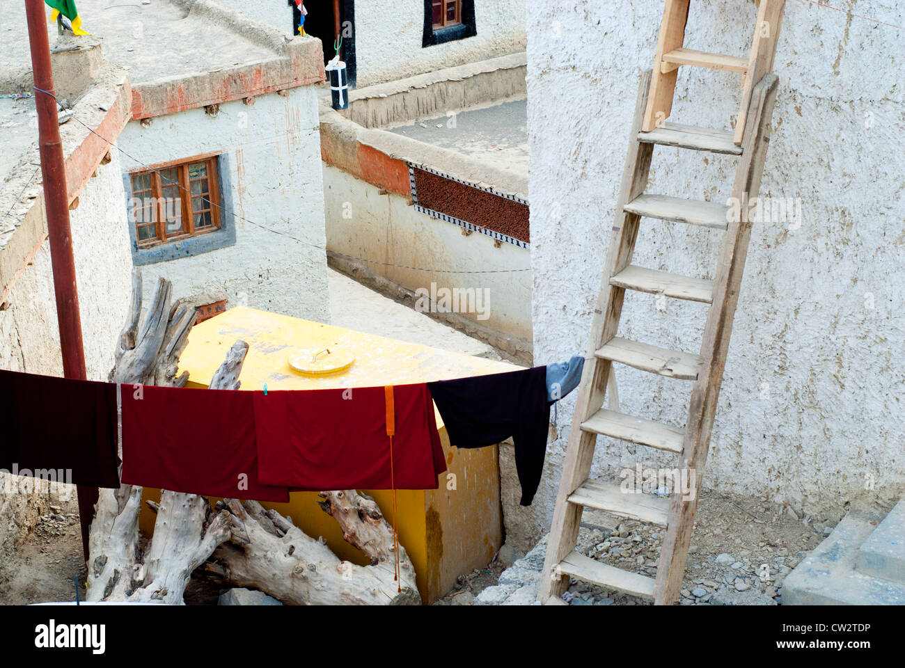 A detail of buildings and a courtyard at Lamayuru Monastery showing drying laundry and a ladder in Ladakh, India Stock Photo