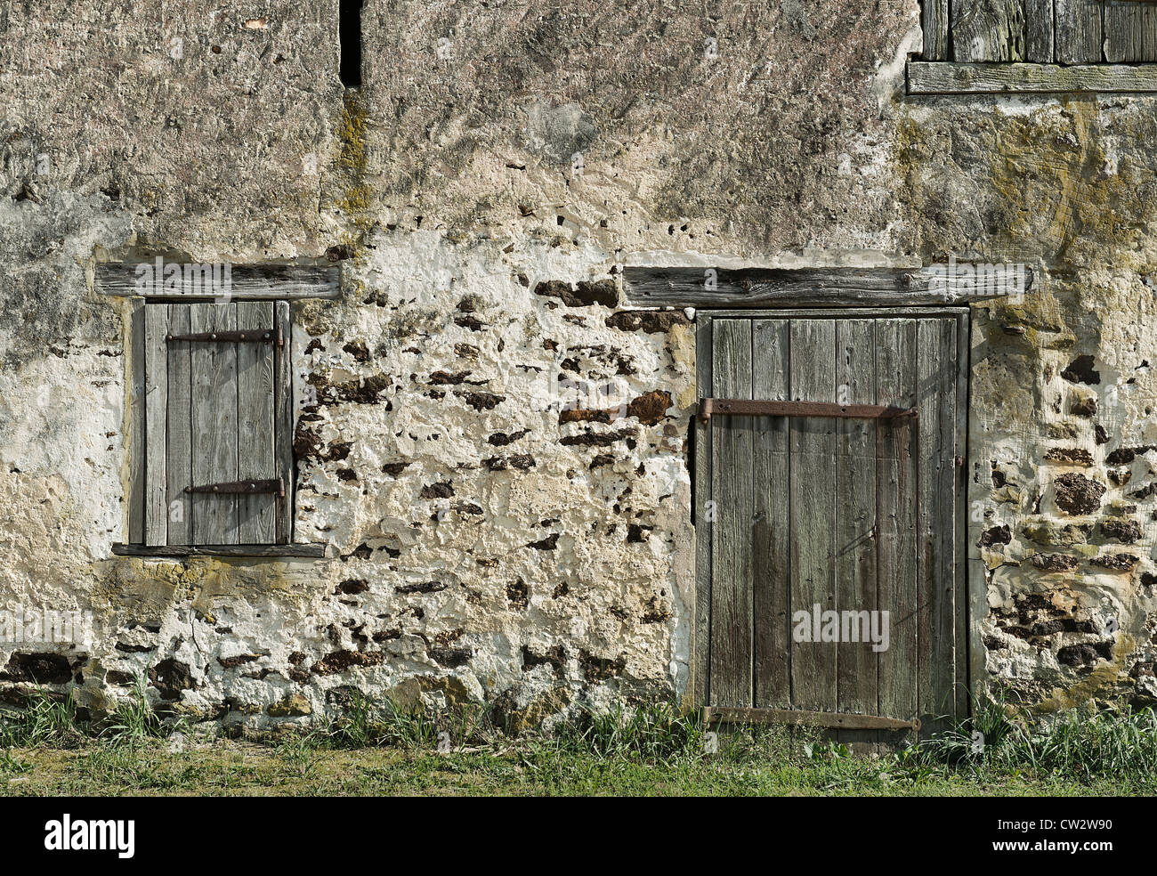 Old stone barn facade. Stock Photo