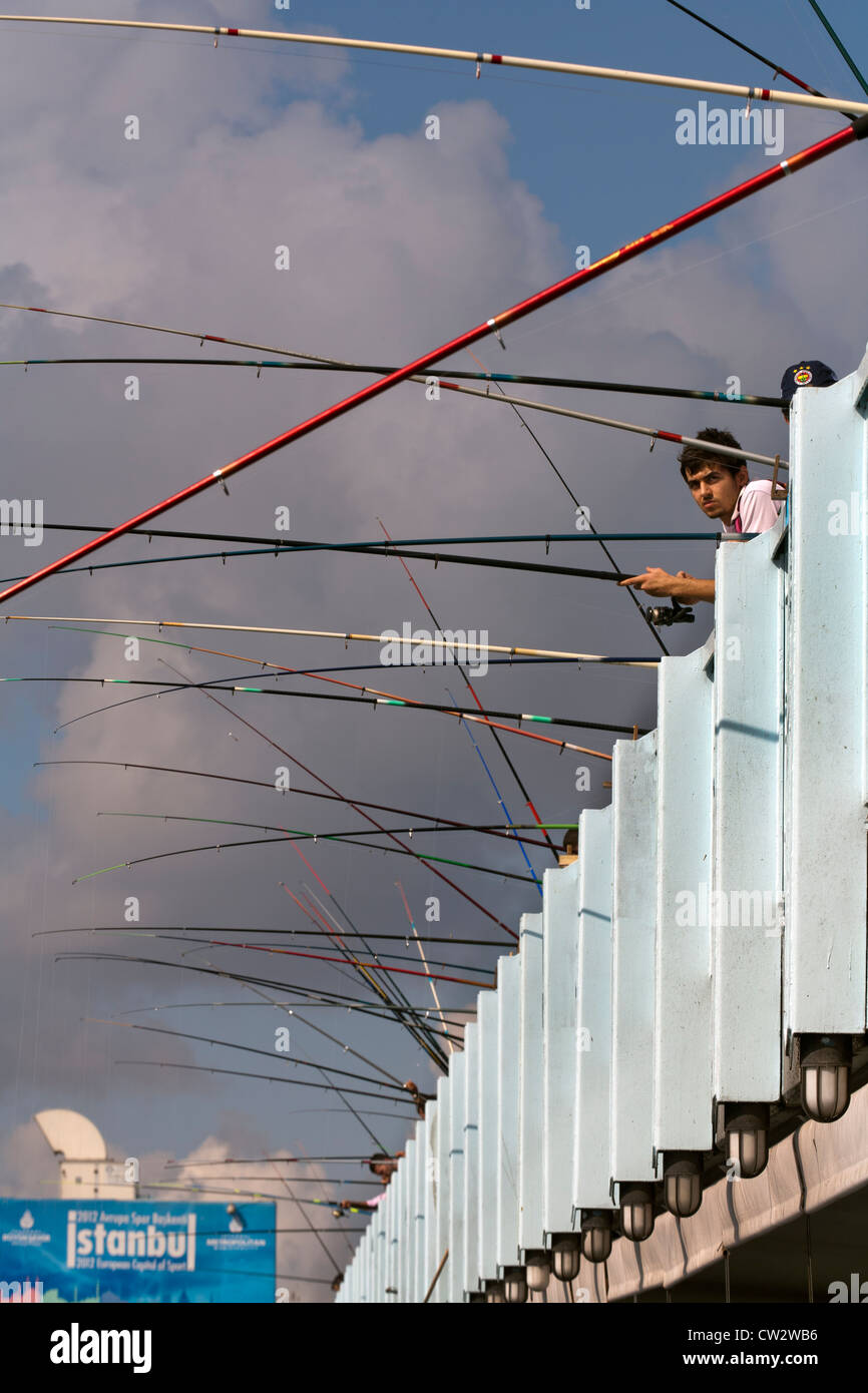 People fishing on Galata Bridge across the Golden Horn, Istanbul, Turkey Stock Photo