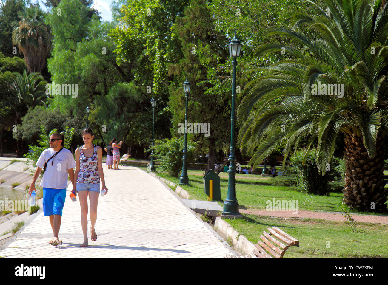 Mendoza Argentina,Parque General San Martin,public park,pathway,landscaping,vegetation,Hispanic man men male,woman female women,couple,stroll,summer c Stock Photo