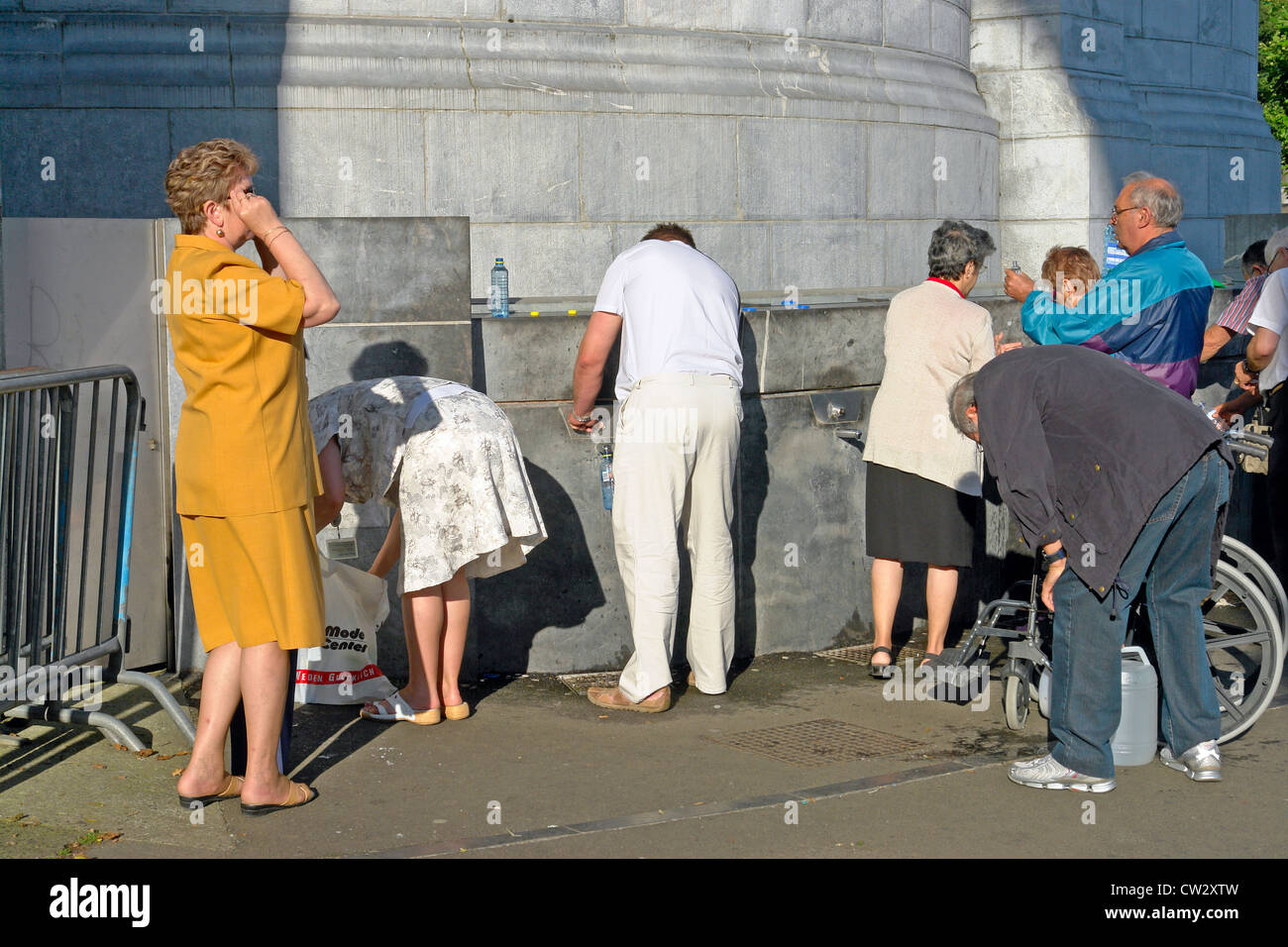 Collecting Lourdes spring water from the Sanctuary of our Lady of Lourdes ,Haute-Pyrenees, France Stock Photo