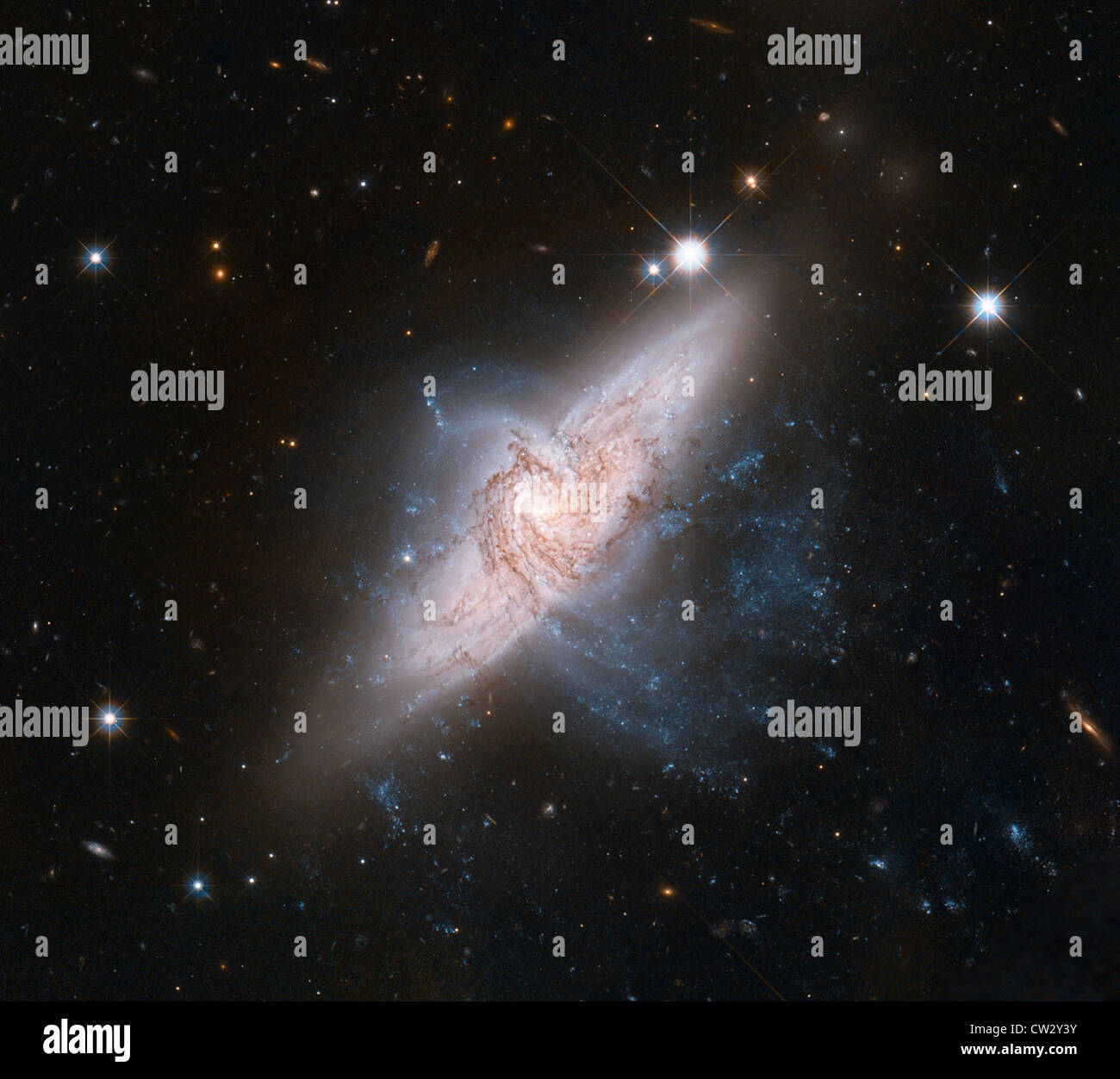 Overlapping galaxies called NGC 3314. The two are in chance alignment from our vantage point. Stock Photo