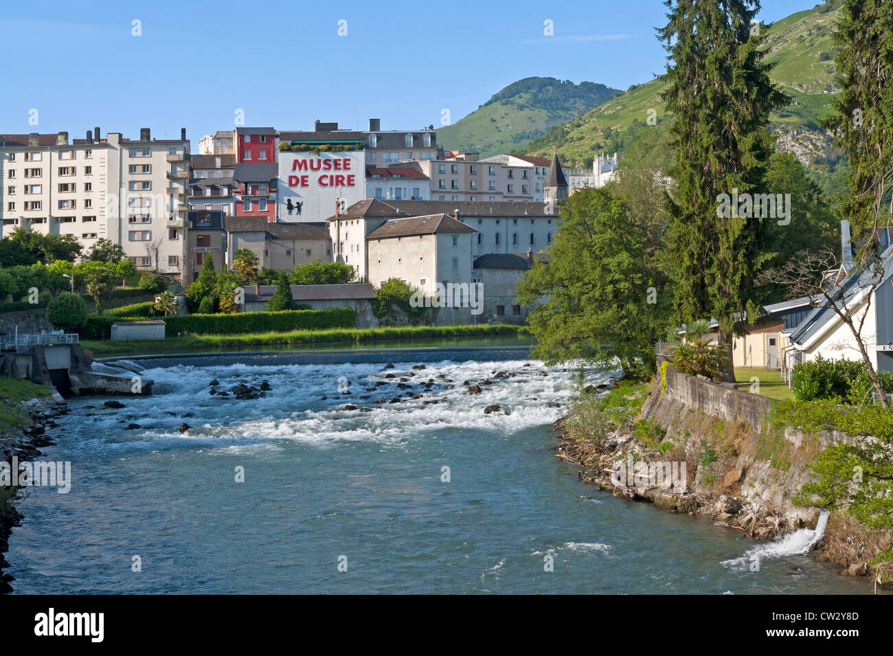 Looking across the river Gave de Pau towards the town on Lourdes, Haute ...