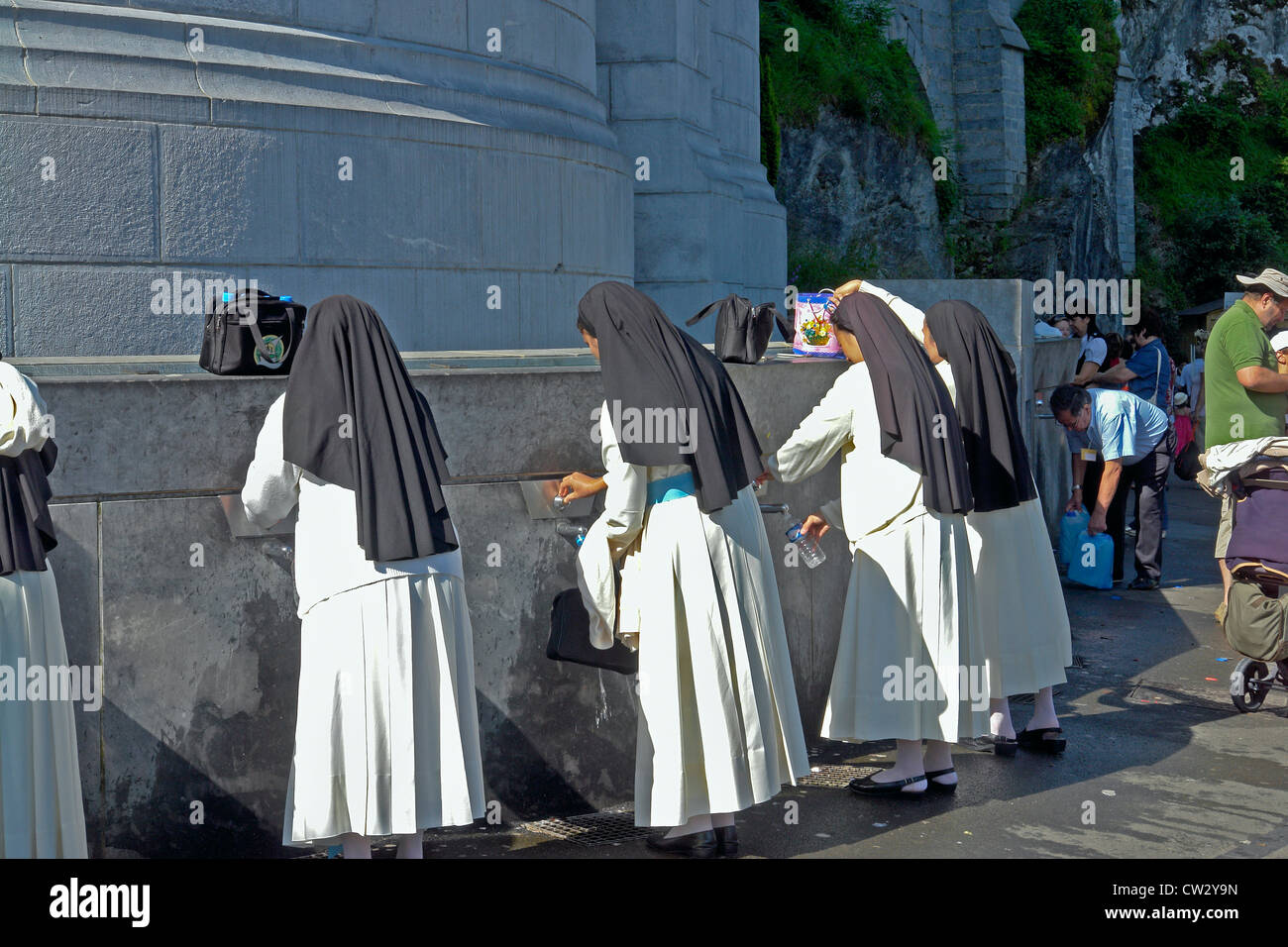 Collecting Lourdes spring water from the Sanctuary of our Lady of Lourdes ,Haute-Pyrenees, France Stock Photo