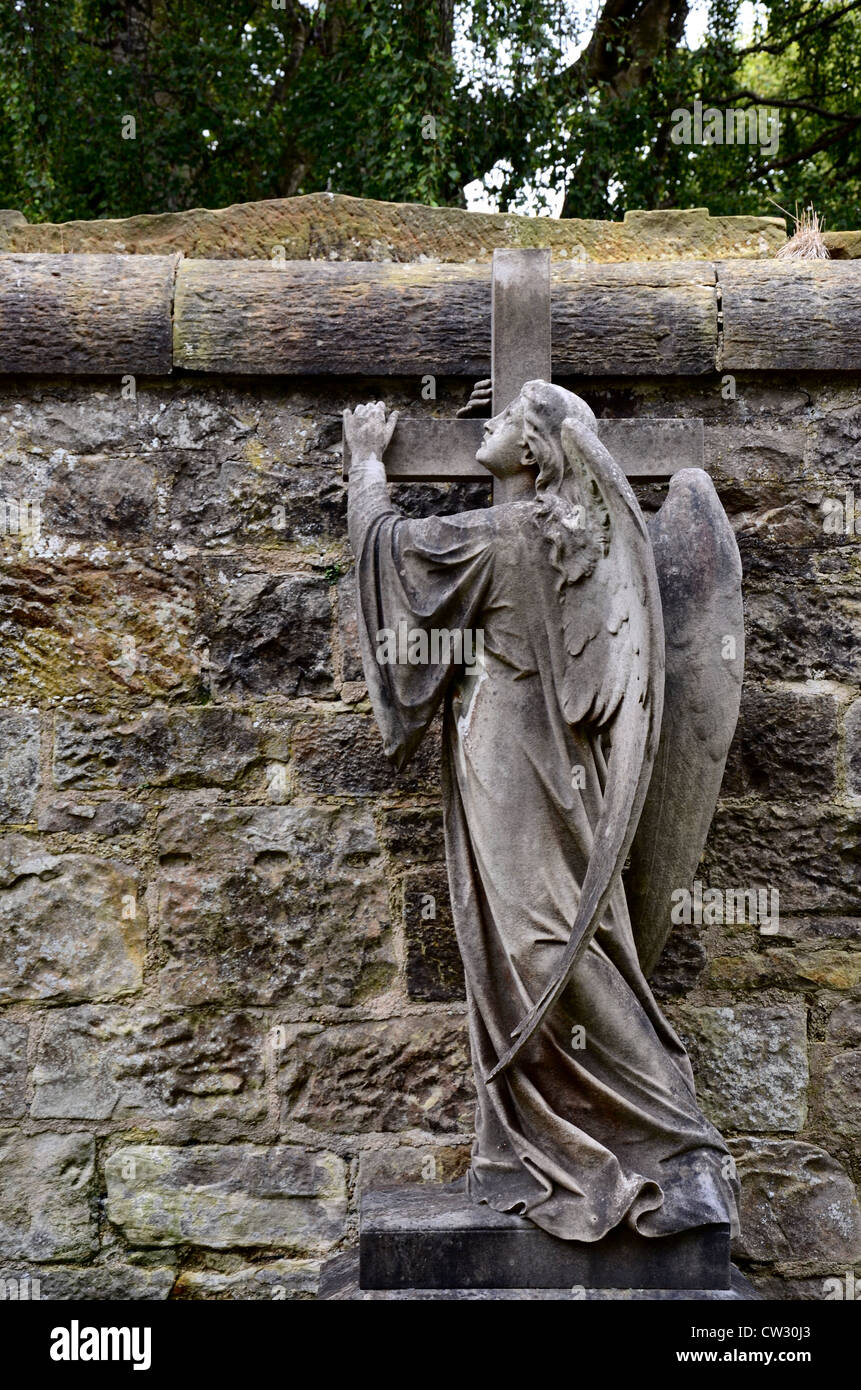 Statue of an angel holding a cross in the Dean Cemetery Edinburgh, Scotland, UK. Stock Photo