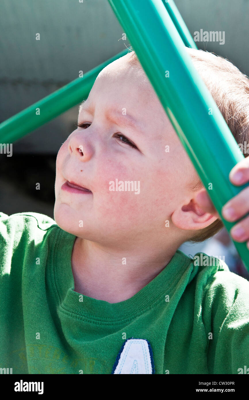 small fair haired boy climbing pipe ladder to look at exhibit at Heritage Flight Museum Bellingham International Airport Stock Photo