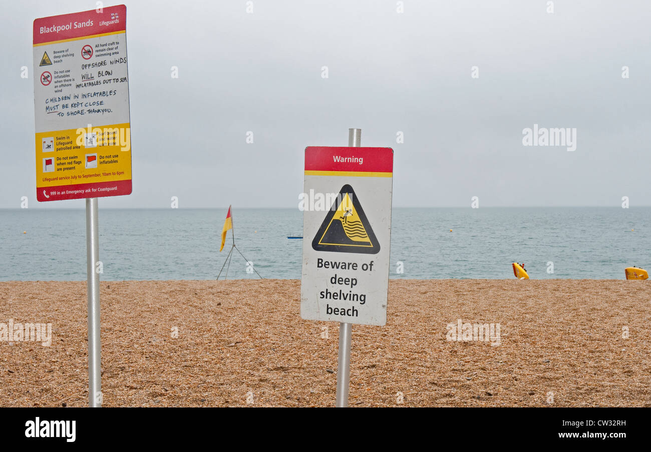 Warning signs on Blackpool Sands beach near Stoke Fleming in Devon. Stock Photo