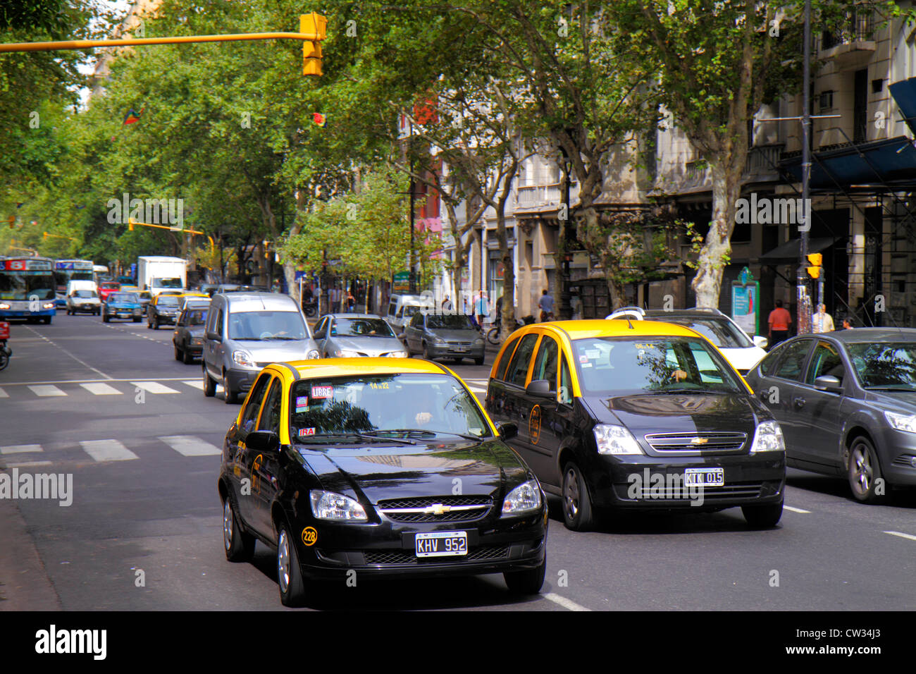 Buenos Aires Argentina,Avenida de Mayo,district,street scene,tree lined avenue,traffic,one way,car,auto,taxi,taxis,cab,cabs,Black yellow,transportatio Stock Photo