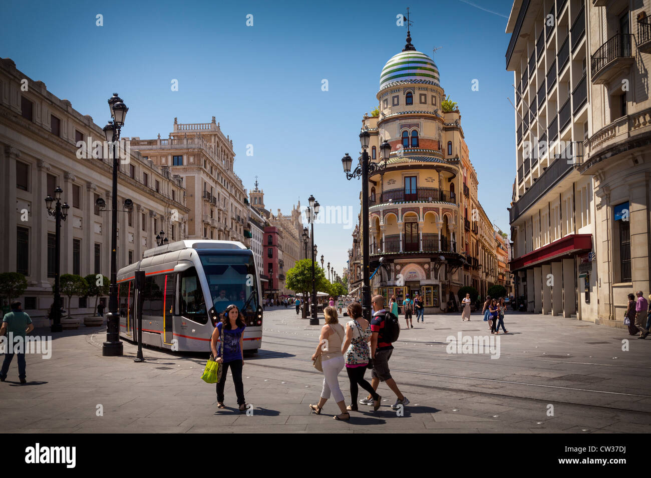 Seville, Andalusia, Spain, Europe. Street scene with modern tram system running through the city center. Stock Photo