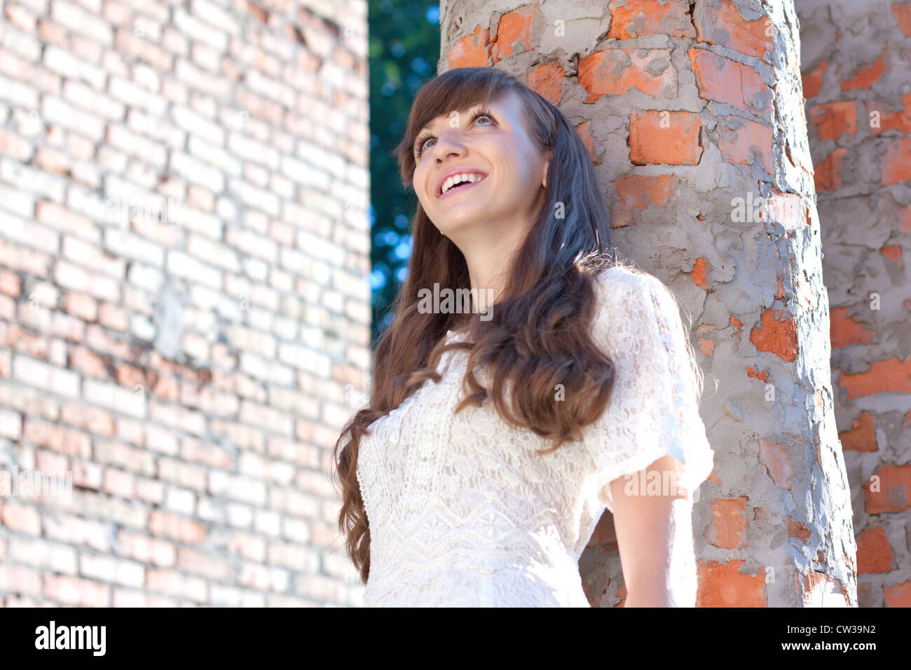 Pretty smilling girl and brick walls Stock Photo