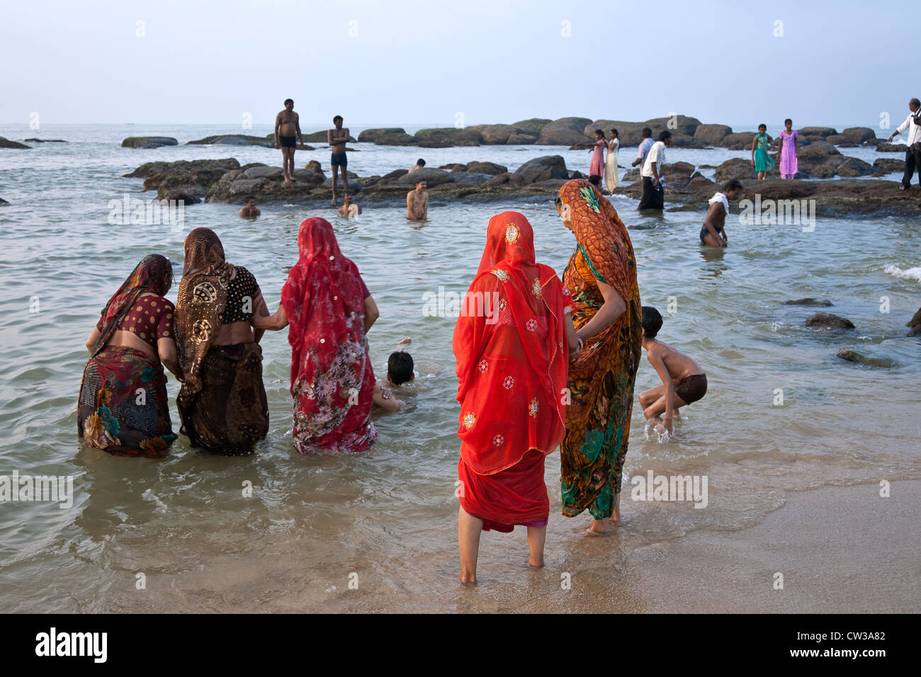 Hindu women bathing in the sea. Kanyakumari. Tamil Nadu. India Stock Photo