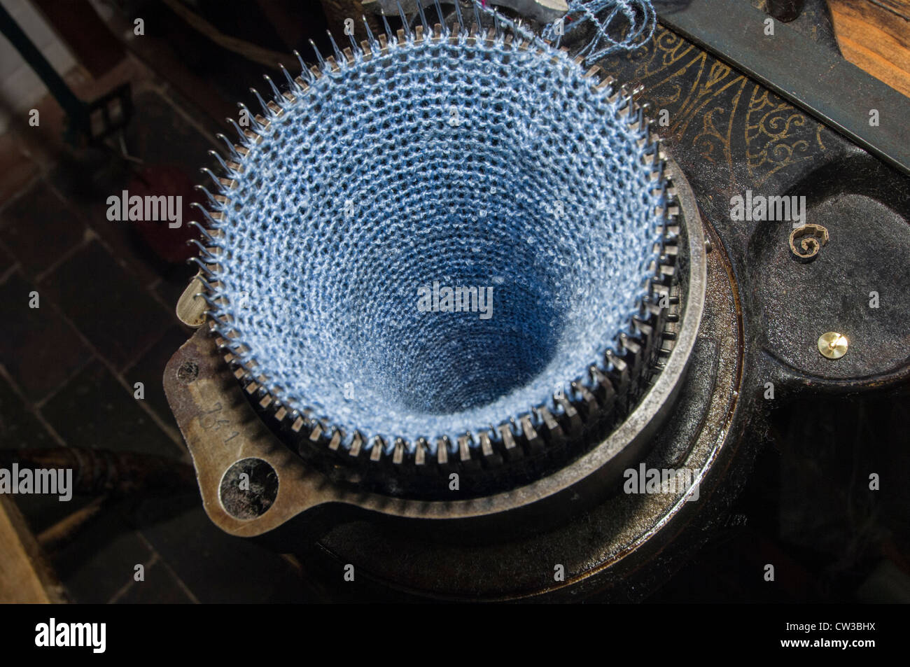 Circular knitting machine, with part manufactured knitting. Stock Photo