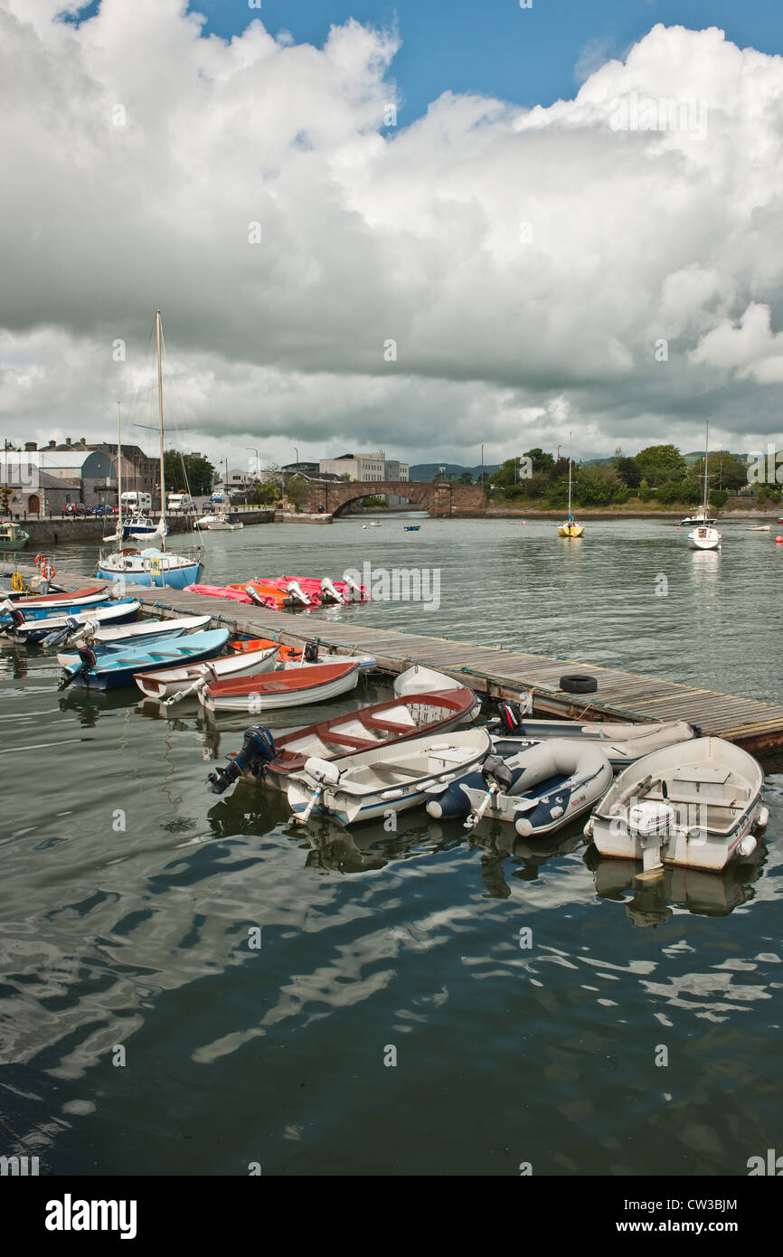 A collection of boats surrounding the jetty at Dungarvan harbour in Ireland. Stock Photo