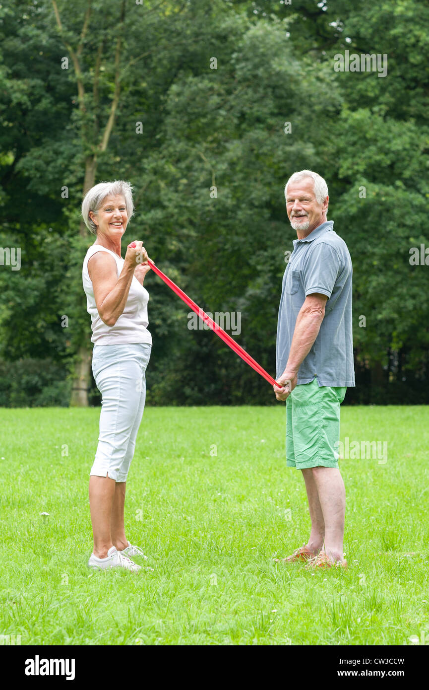 Active senior couple in the park doing gymnastics Stock Photo - Alamy