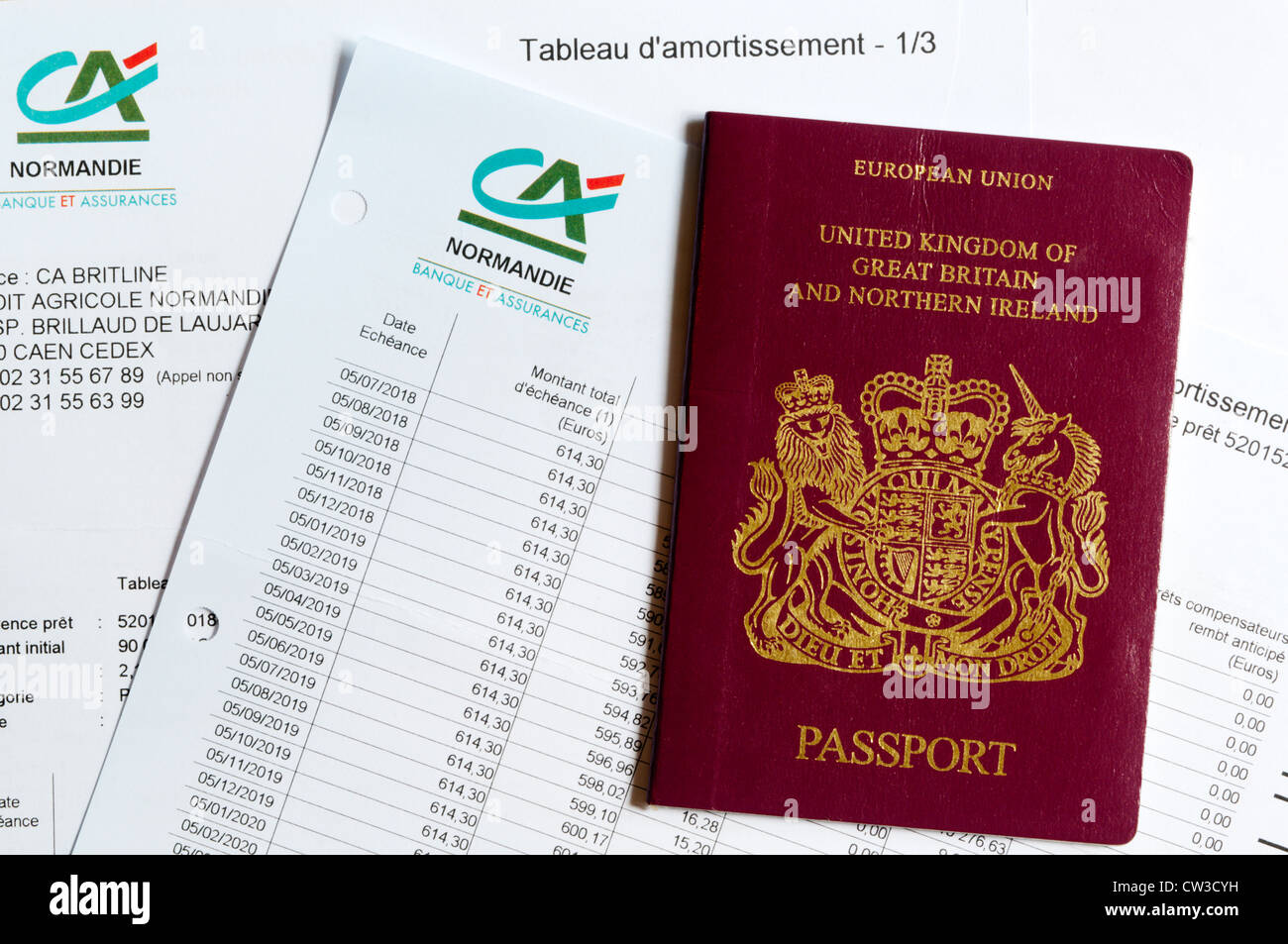 A British passport laying on a mortgage repayment schedule. Stock Photo