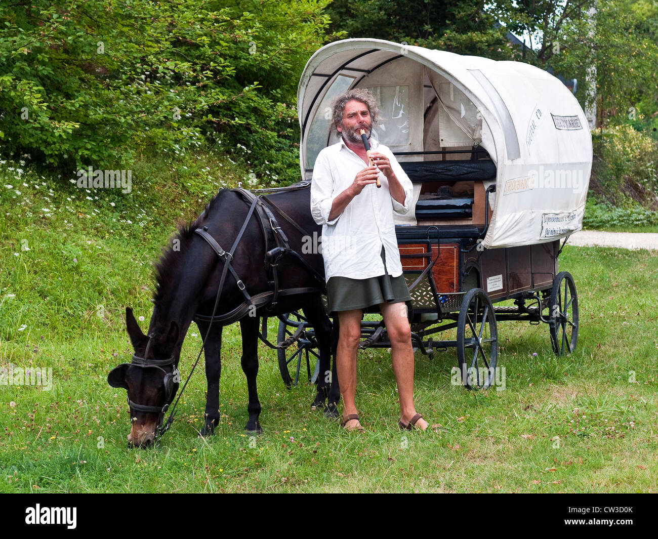 Troubadour with mule-drawn wooden caravan - France. Stock Photo