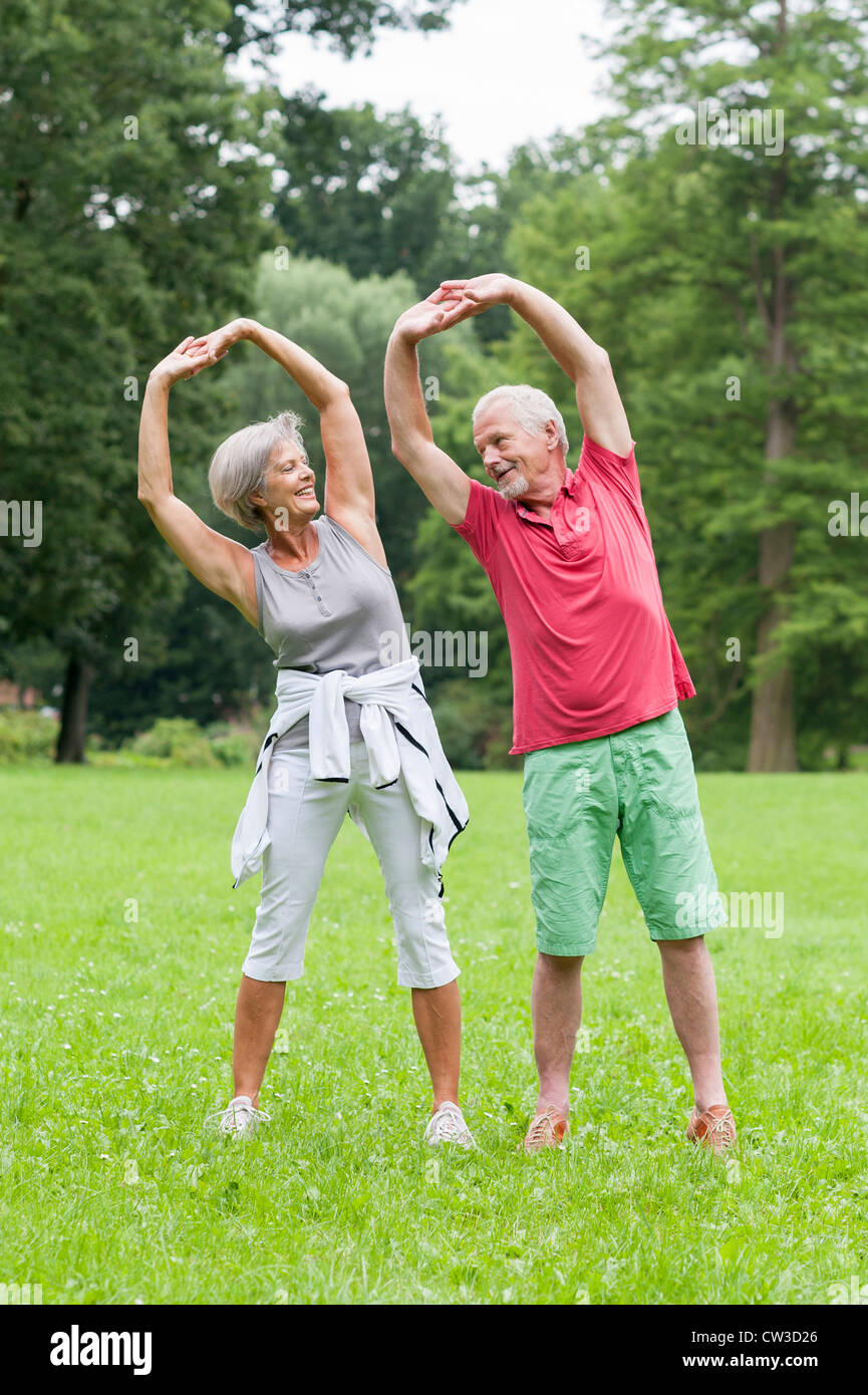 Active senior couple in the park doing gymnastics Stock Photo - Alamy