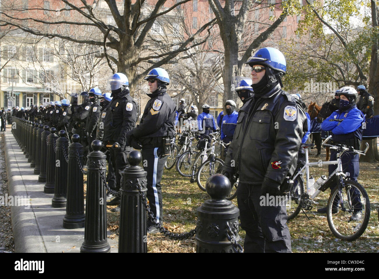 Members of the US Park Police stand guard outside of Pershing Park near the White House during a large anti war rally leading up Stock Photo