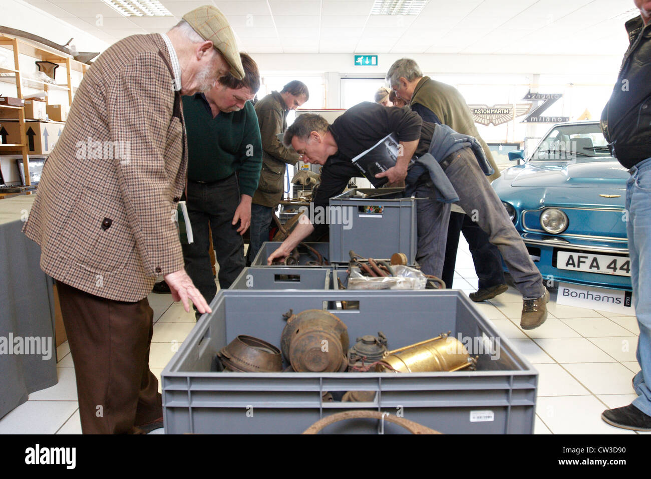 Potential buyers examine lots forming part of a classic car auction at