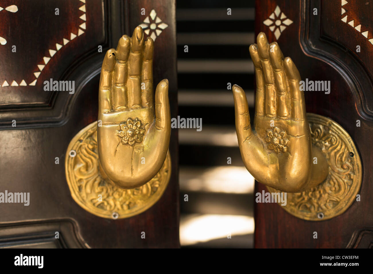 brass hands on door Stock Photo